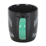 Black mug with a green handle on a white background