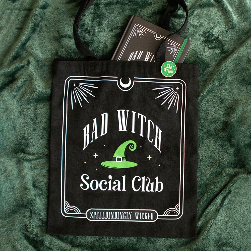 Black tote bag with 'Bad Witch Social Club' design on a green textured background