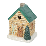Small decorative log cabin with a green roof and tree on a white background