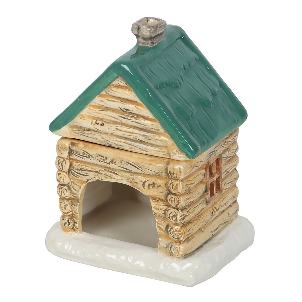 Small ceramic log cabin with green roof on a white background