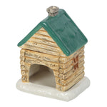 Small ceramic log cabin with green roof on a white background