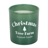 Green candle with 'Christmas Tree Farm Scented Candle' text and tree graphic on a white background