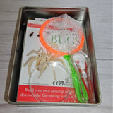 A tin educational set called 'Discover Bugs' with images of various insects and scientific tools like a magnifying glass and tweezers.