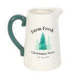 White pitcher with green handle featuring 'Farm Fresh Christmas Trees' text and tree illustrations on a white background.