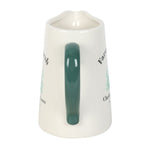 White mug with green handle on a white background