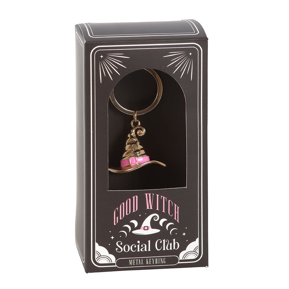 Keychain with a witch hat design in a 'Good Witch Social Club' packaging on a white background