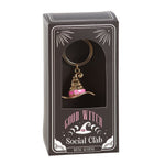 Keychain with a witch hat design in a 'Good Witch Social Club' packaging on a white background