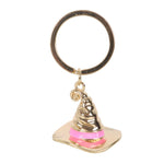Gold and pink Sorting Hat keychain on a white background