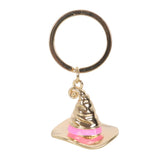 Gold and pink Sorting Hat keychain on a white background
