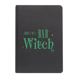 Black notebook with green text 'Today I'm a Bad Witch' on a white background