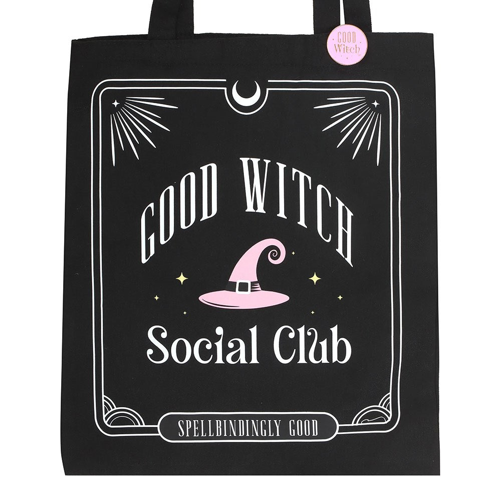 Black tote bag with 'Good Witch Social Club' text and pink witch hat design on a white background