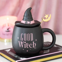 Black mug with witch hat and 'Good Witch' text on a pink background