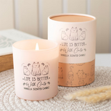 Vanilla scented candle with 'Life is better with cats' text and cat illustrations on a textured surface.
