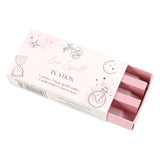 A box labeled 'Magic Love Spell in a Box' with illustrations of a heart and a spellbook. The box contains three pink spell candles.