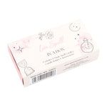 A box labeled 'Magic Love Spell in a Box' with illustrations of a heart and a spellbook. The box contains three pink spell candles.