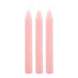 A box labeled 'Magic Love Spell in a Box' with illustrations of a heart and a spellbook. The box contains three pink spell candles.