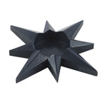 Black geometric star-shaped object on a white background