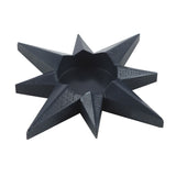 Black geometric star-shaped object on a white background
