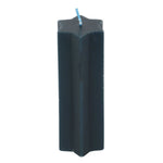 Black candle with a blue wick on a white background