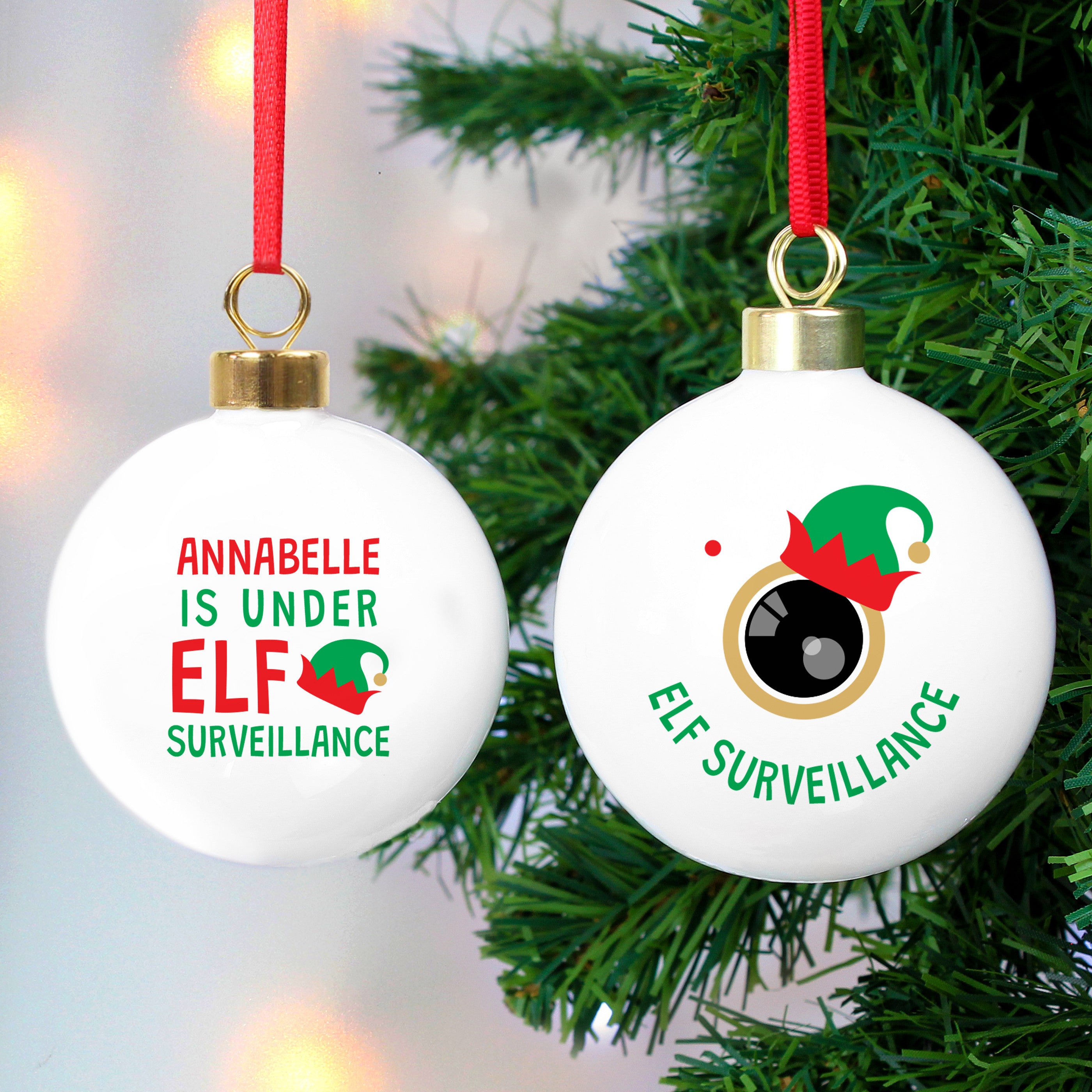 Two round Christmas ornaments with a green and red colour scheme. The first ornament has the text 'Anna is under ELF surveillance' and the second one says 'Elf surveillance'.