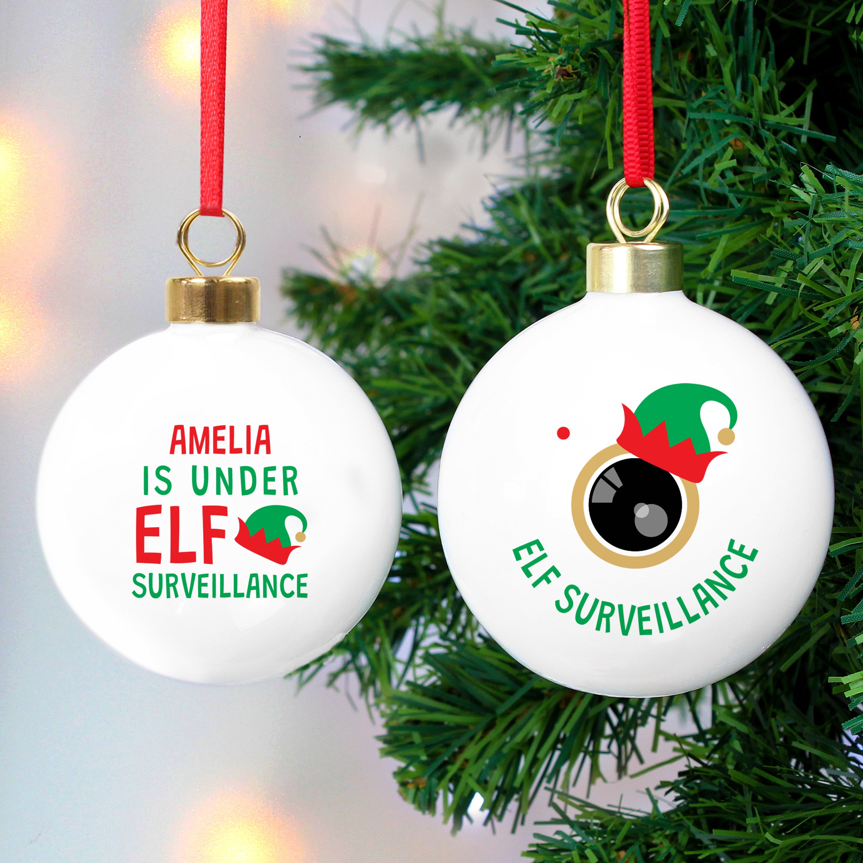 Two round Christmas ornaments with a green and red colour scheme. The first ornament has the text 'Anna is under ELF surveillance' and the second one says 'Elf surveillance'. 01