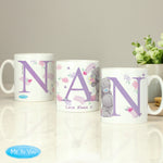 Three ceramic mugs with 'Nan' written on each, featuring floral and animal designs, placed on a table with a 'Me To You' logo in the corner.