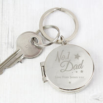 A silver-colored keyring with 'No.1 Dad' inscribed on it alongside a personal message 'Love from James Xx'.