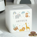 A white ceramic square money box with a personalised name 'Arthur' and a jungle animal theme, featuring illustrations of an elephant, giraffe, monkey, lion, and zebra.