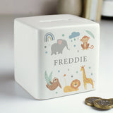 A white ceramic square money box with a personalised name 'Arthur' and a jungle animal theme, featuring illustrations of an elephant, giraffe, monkey, lion, and zebra.