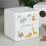 A white ceramic square money box with a personalised name 'Arthur' and a jungle animal theme, featuring illustrations of an elephant, giraffe, monkey, lion, and zebra.