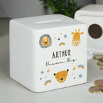 A white ceramic square money box with a personalised inscription and decorated with safari animal illustrations, including a lion and a giraffe, and the name 'Noah'.