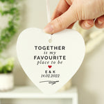 Hand holding a personalised hanging sign with the words 'together is my favourite place to be' 
