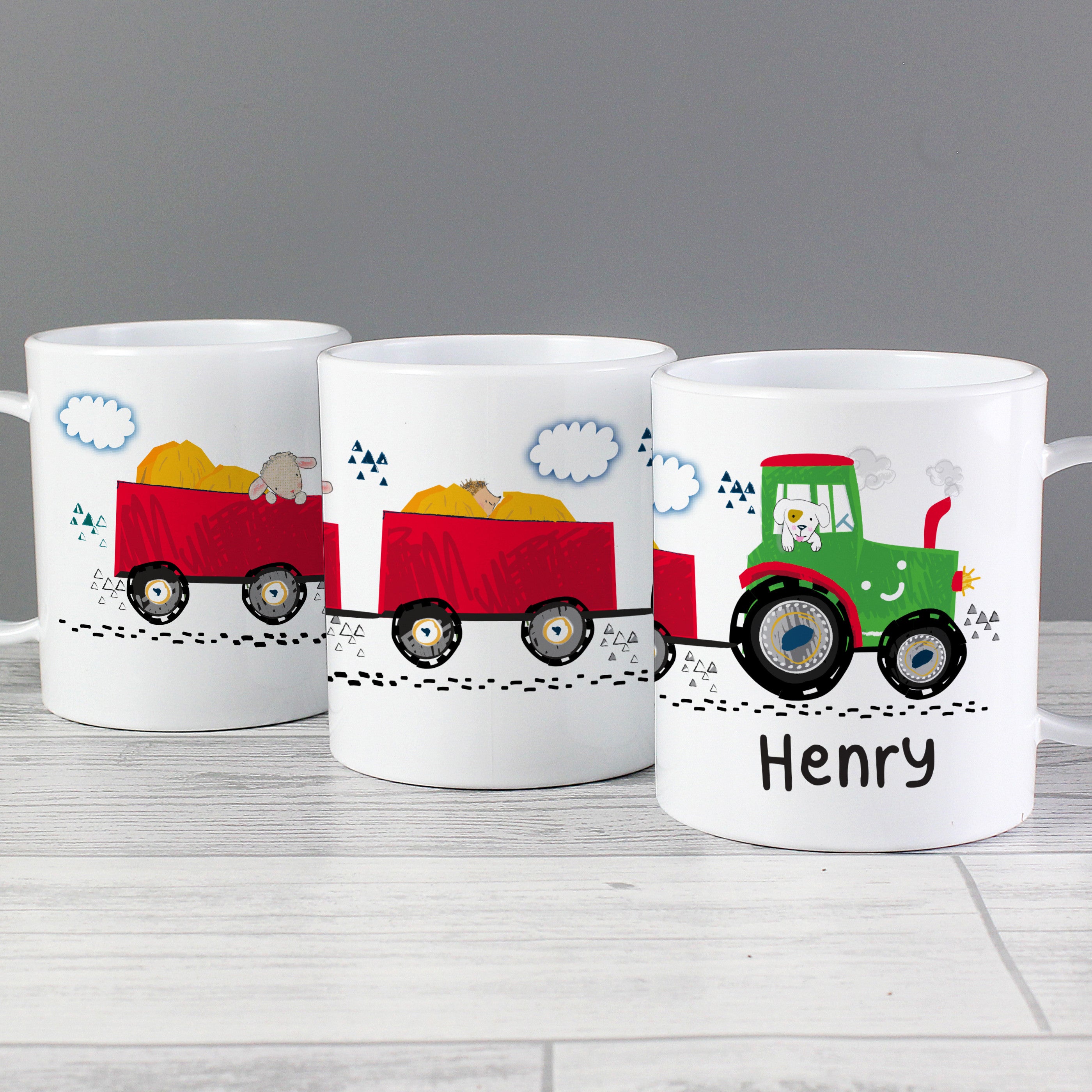 A set of three personalised plastic mugs with tractor designs, each with a different colour tractor and the name 'Benjamin' printed on one of them.