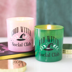 Two candles, one pink and one green, with 'Good Witch Social Club' and 'Bad Witch Social Club' text.