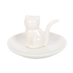 White ceramic cat-shaped object on a round base with a white background