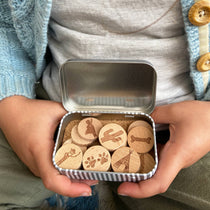 an open box of story tokens which a little boy is holding 