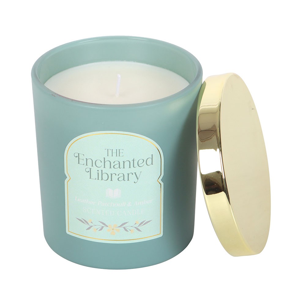 Candle in a teal container with a gold lid labeled 'The Enchanted Library' on a white background