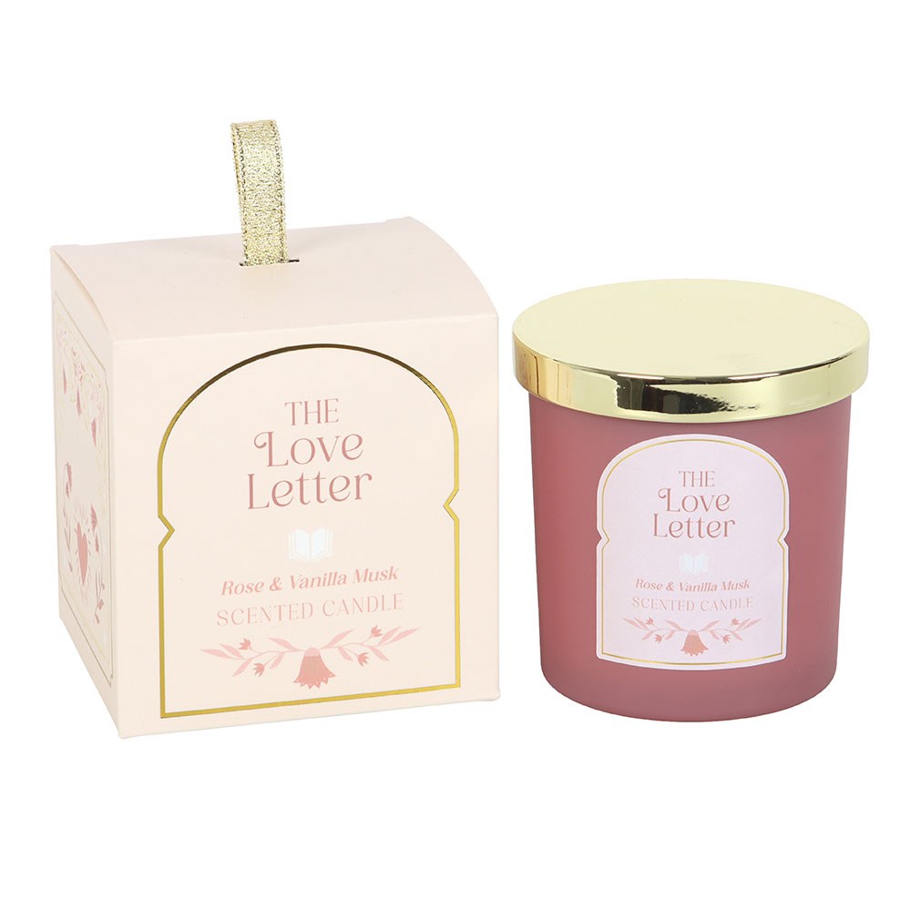 Scented candle with gold lid and packaging labeled 'The Love Letter' on a white background