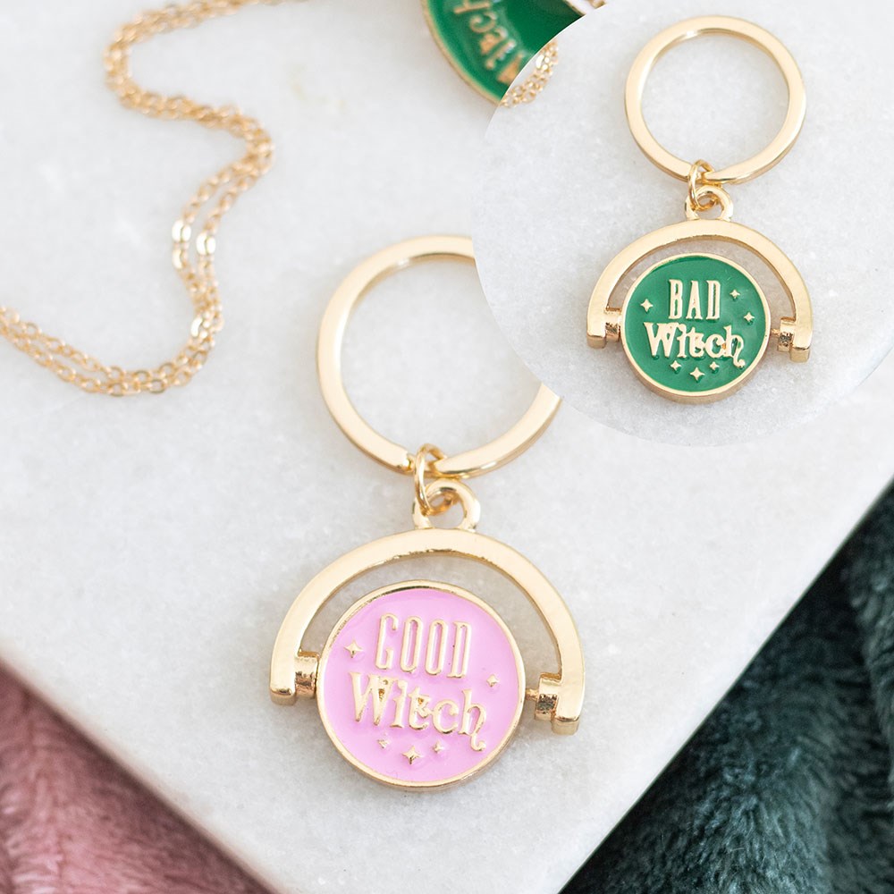 Two keychains with 'Good Witch' and 'Bad Witch' text on a white surface.
