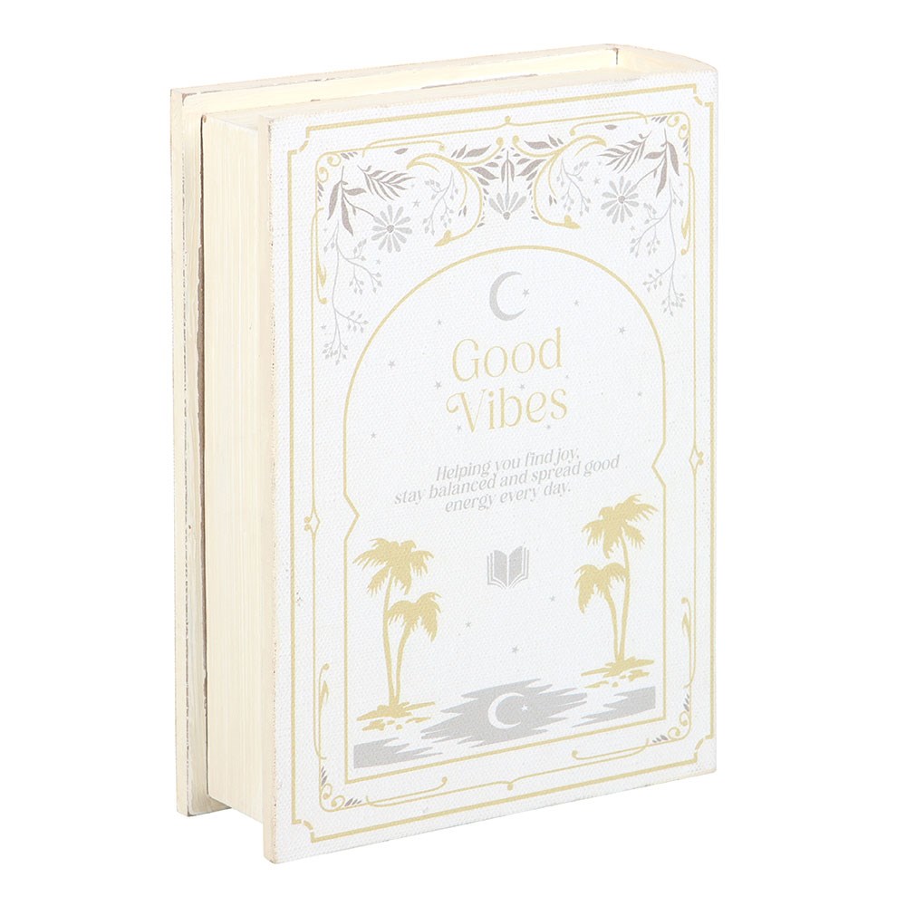 Decorative book titled 'Good Vibes' with palm tree and moon design on a white background