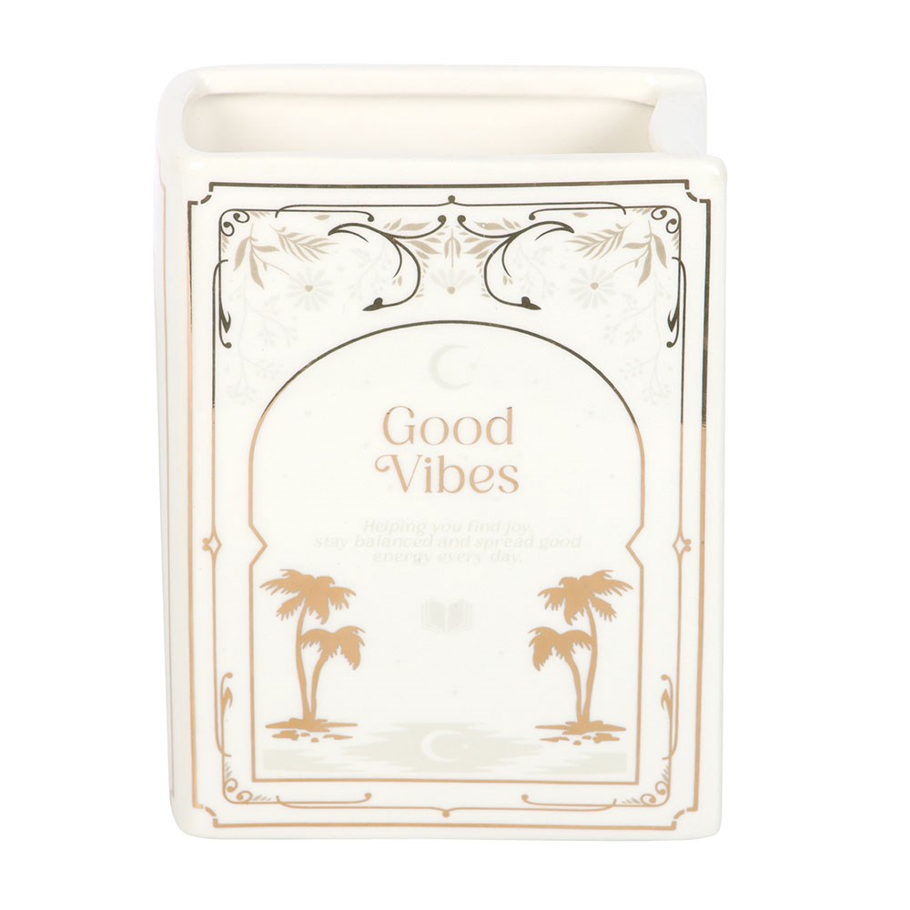 Candle with 'Good Vibes' text and palm tree designs on a white background