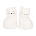 Two white cat-shaped salt and pepper shakers on a white background