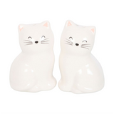Two white cat-shaped salt and pepper shakers on a white background